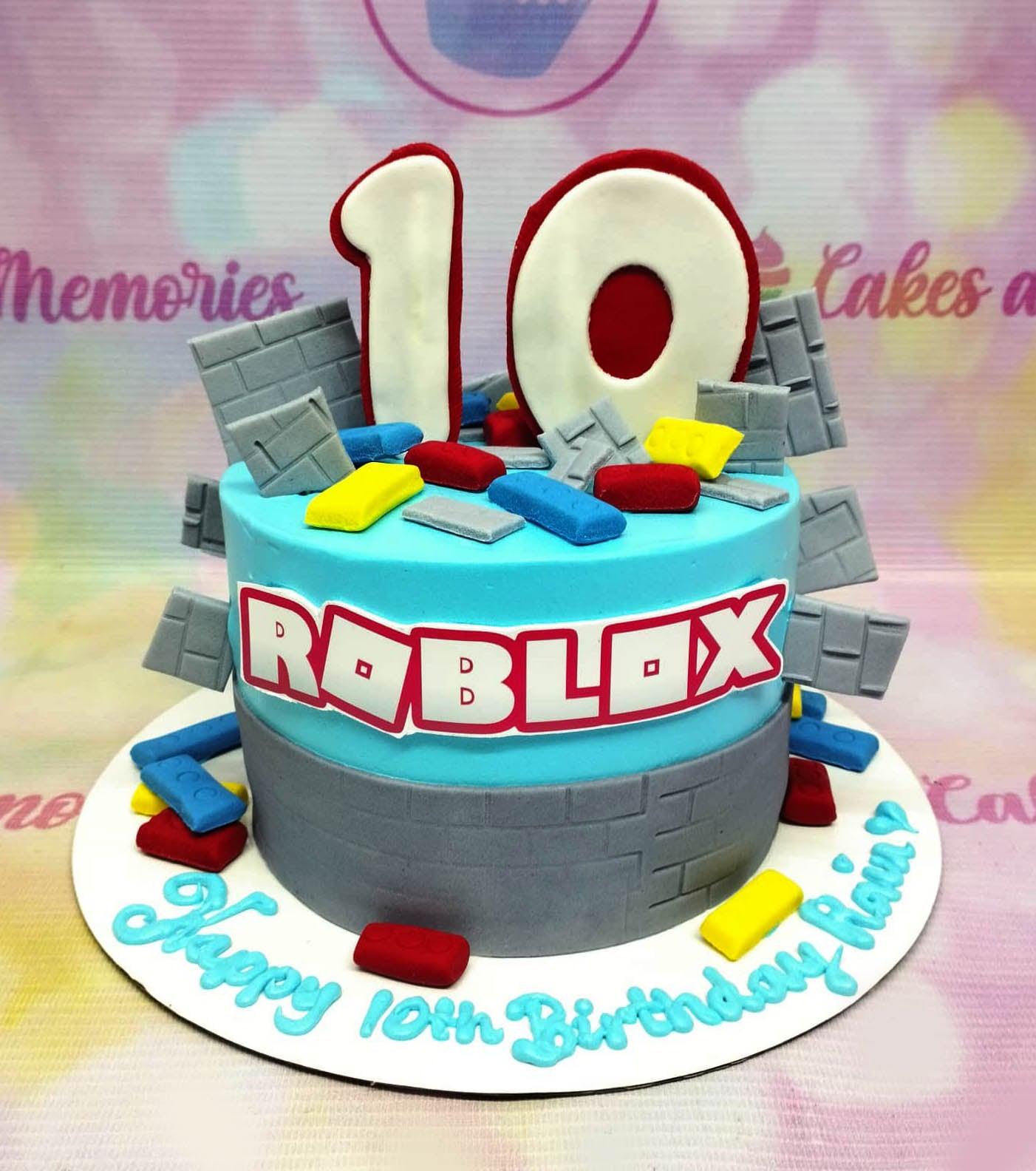 Roblox themed birthday cake with blue and gray icing, fondant building blocks, and a large number 10 topper.