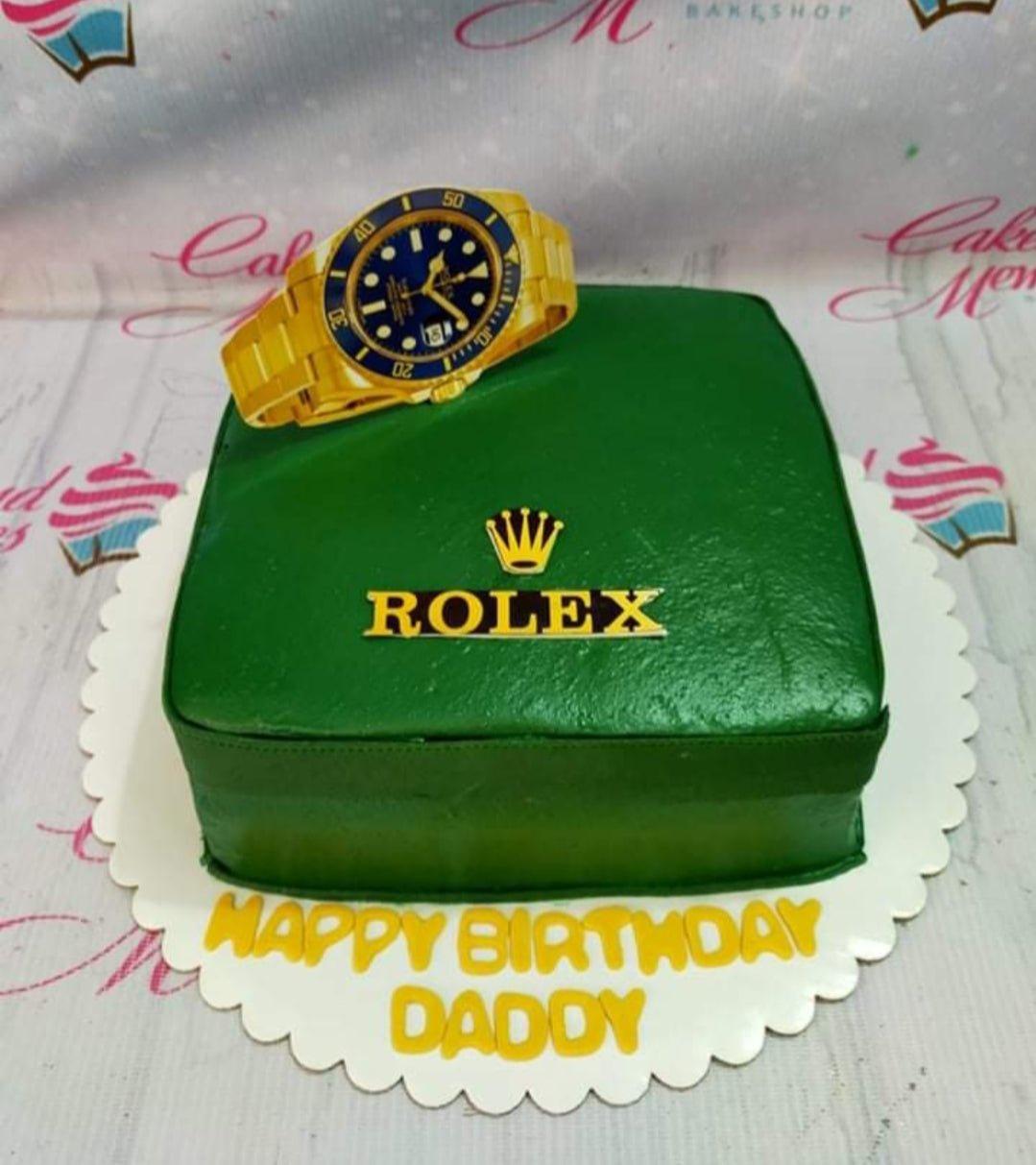 Green square Rolex watch themed cake with a gold watch topper and yellow birthday message on the base board.