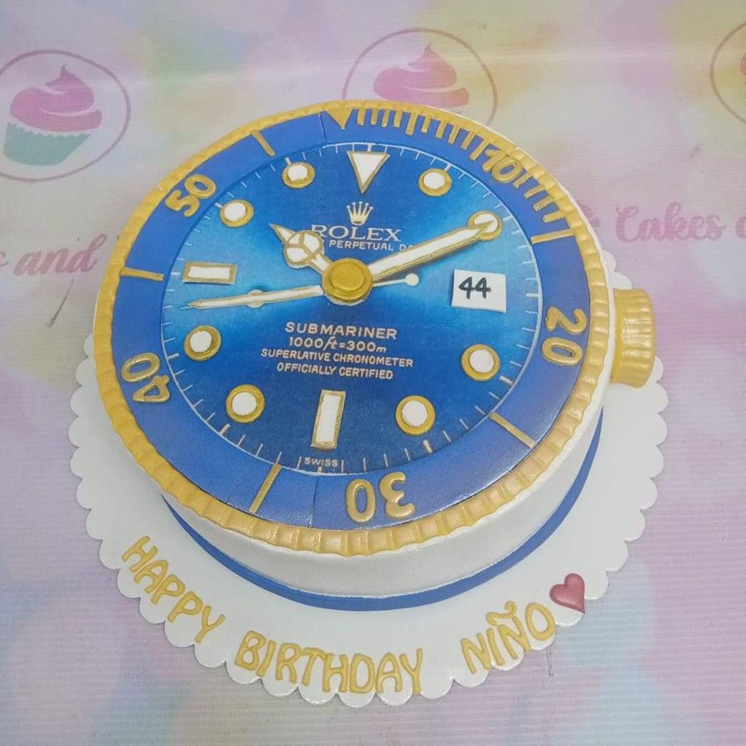 Rolex Submariner watch themed birthday cake with blue dial and gold bezel details