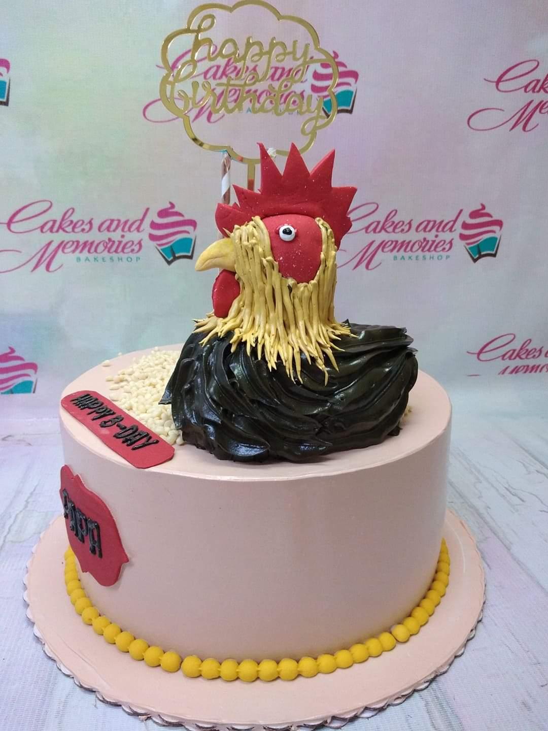 Light pink 1-tier cake featuring a large 3D fondant rooster topper with black icing feathers and a gold Happy Birthday topper.