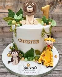 White 1-tier safari cake with fondant lion, giraffe, monkey, and gold number one topper