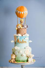 3-tier safari cake with hot air balloon topper, fondant lion, elephant, and giraffe figures