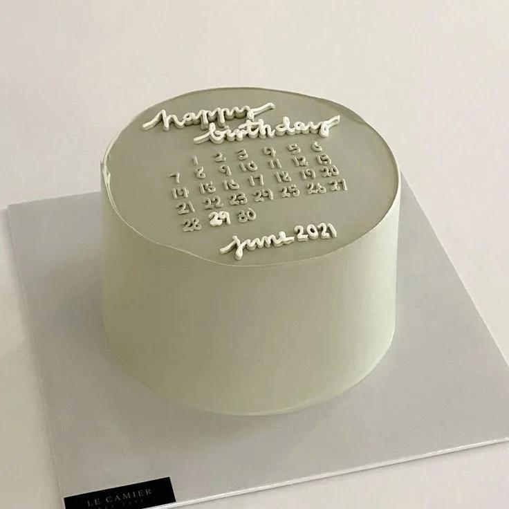 Minimalist sage green calendar cake with white icing text for a June 2021 birthday celebration.