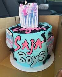 Light blue 1-tier K-pop themed cake with pink and black icing accents and a group photo topper.
