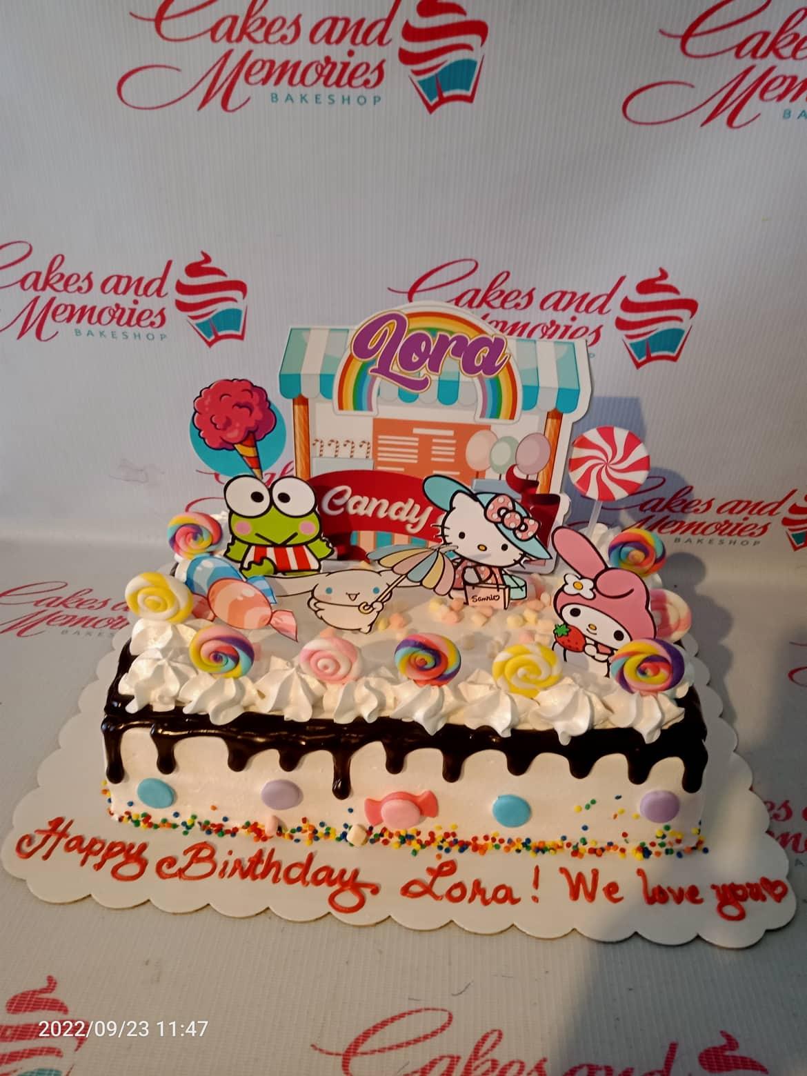 White rectangular Sanrio candy shop cake with Hello Kitty, My Melody, and Keroppi printouts, chocolate drip, and colorful lollipop decorations.