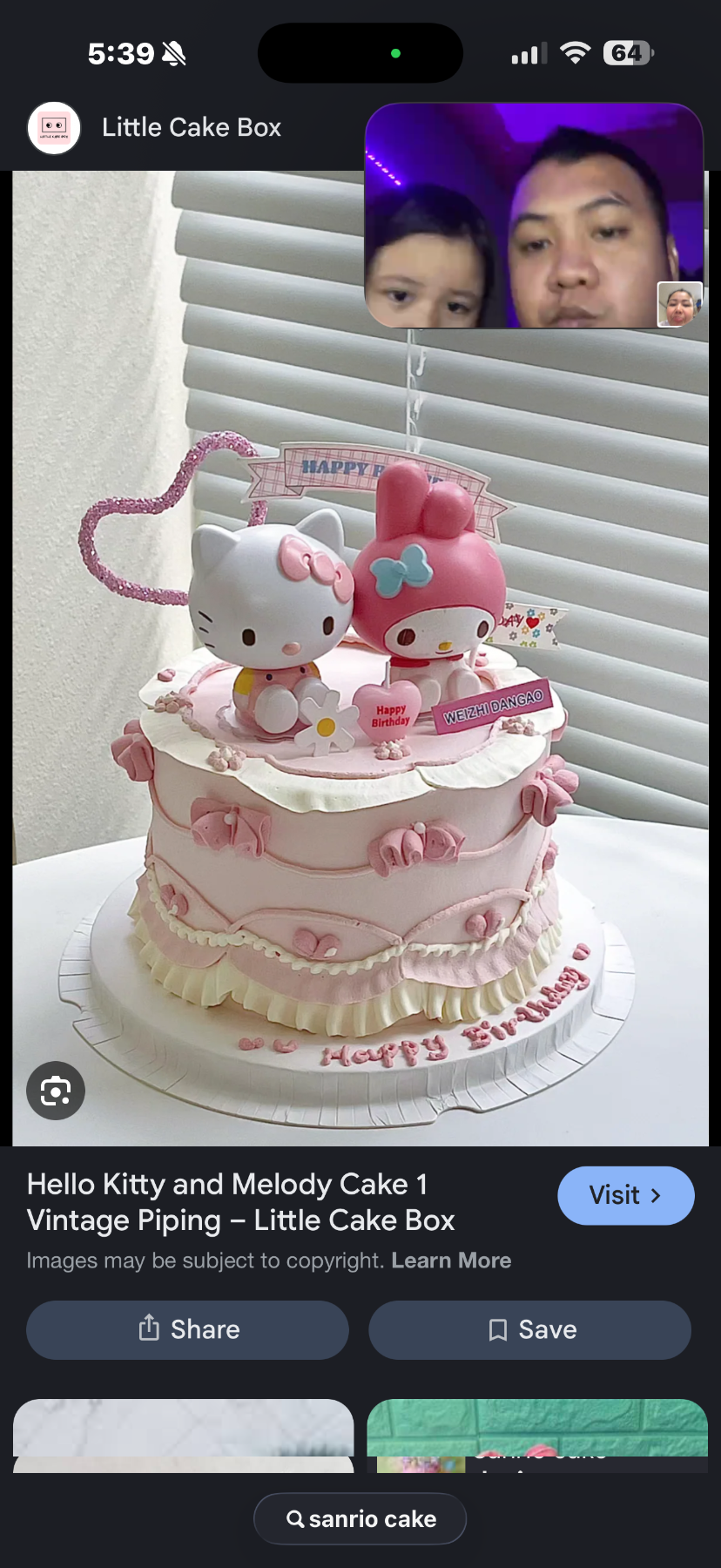 Pink vintage piped cake with Hello Kitty and My Melody toy figurines and heart topper