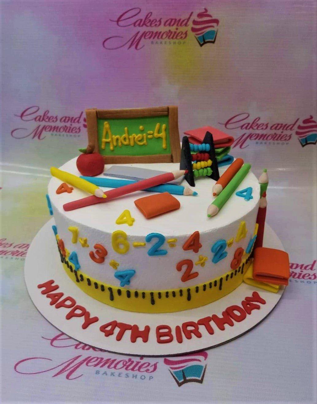 School themed birthday cake with fondant pencils, chalkboard, abacus, and colorful numbers on white icing.