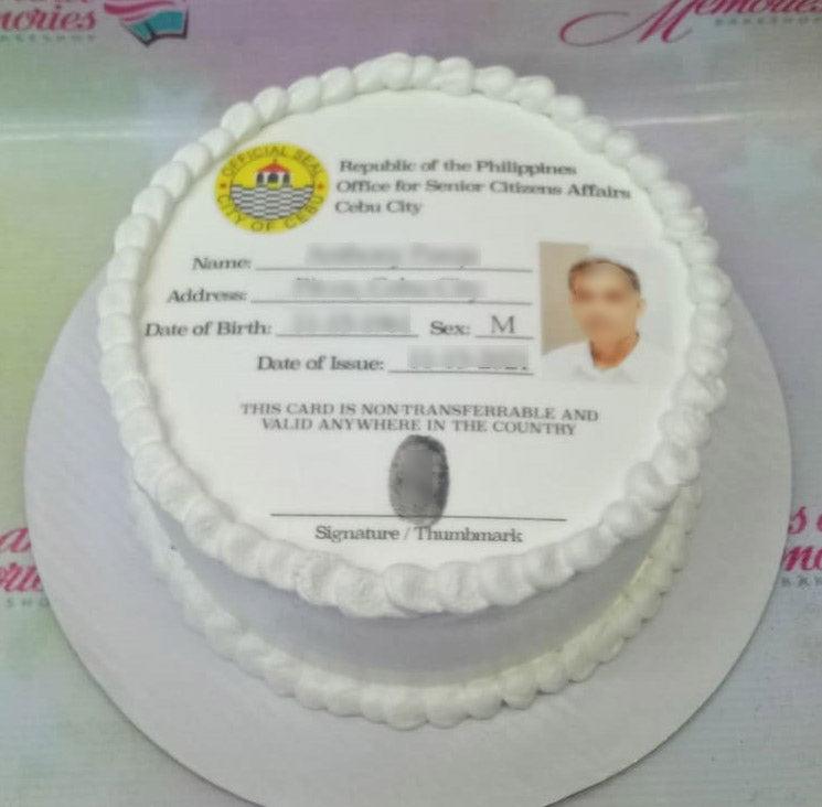 White round cake featuring a printed senior citizen ID card design for a Cebu City resident with white icing borders.