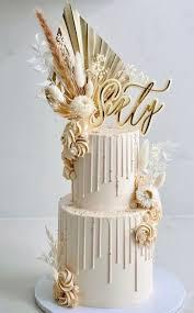 sixty floral 2 Tier - red, cream, gold theme with gold sixty topper and white and beige dried flowers and foliage