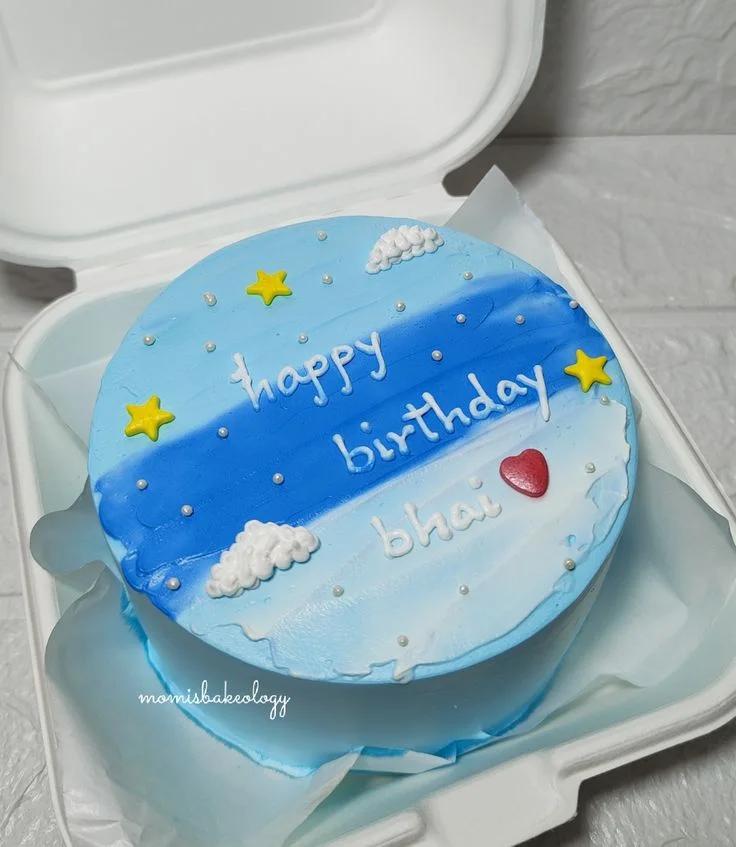 Blue and white bento cake with a sky theme featuring clouds, stars, and a red heart for a birthday celebration.
