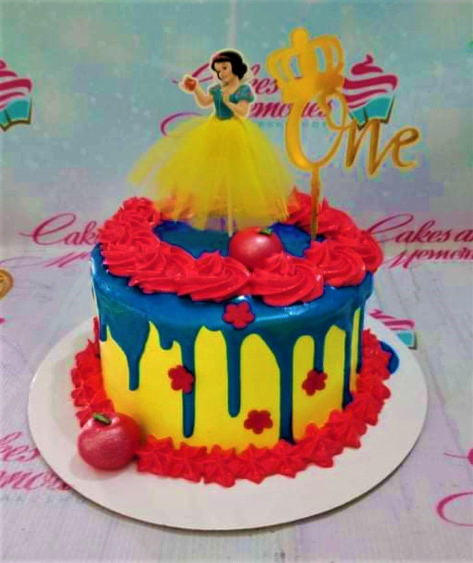 Snow White themed birthday cake with yellow icing, blue drip, red icing rosettes, and a Snow White character topper.