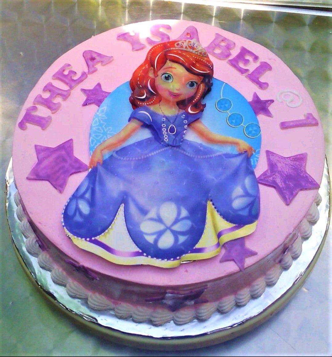 Sofia the First themed pink birthday cake with a large character printout and purple fondant stars.