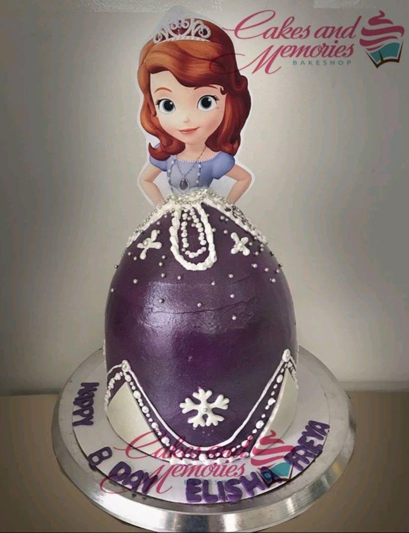 Sofia the First themed dome cake with a purple icing dress design and a character printout topper.