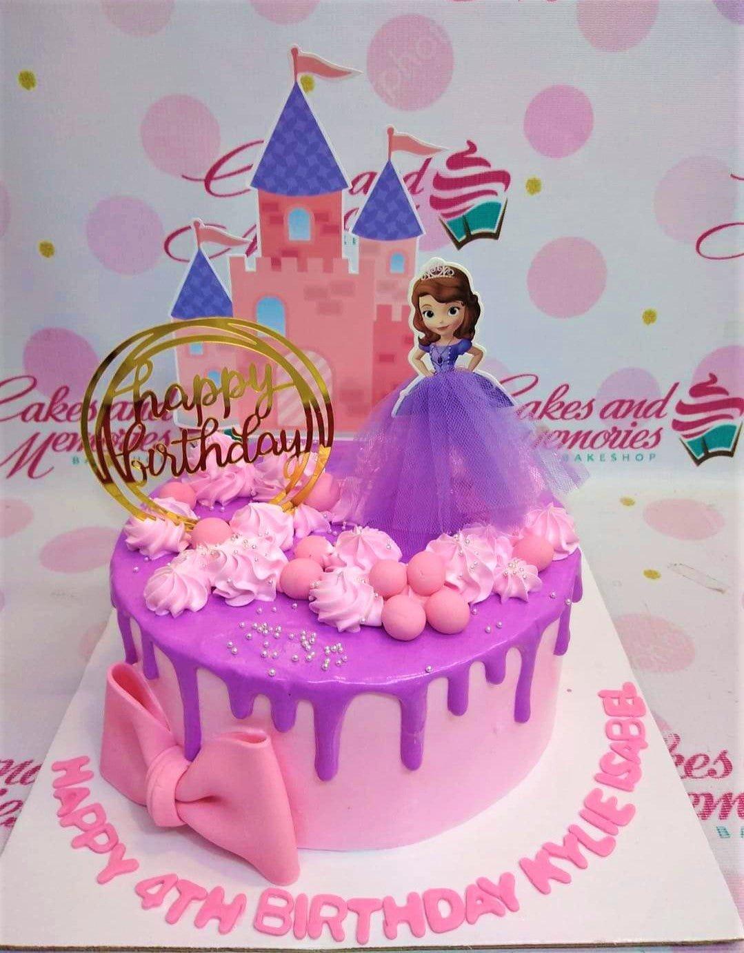 Pink Sofia the First themed birthday cake with a purple castle printout, Sofia character topper, and a gold Happy Birthday cardstock topper.