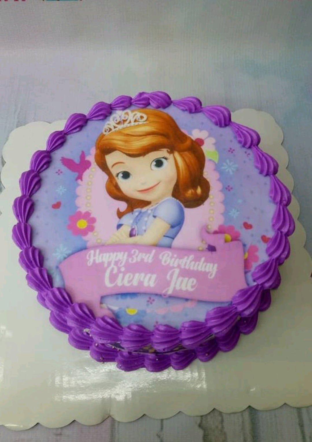 Sofia the First themed birthday cake with purple icing borders and a large character printout on top.