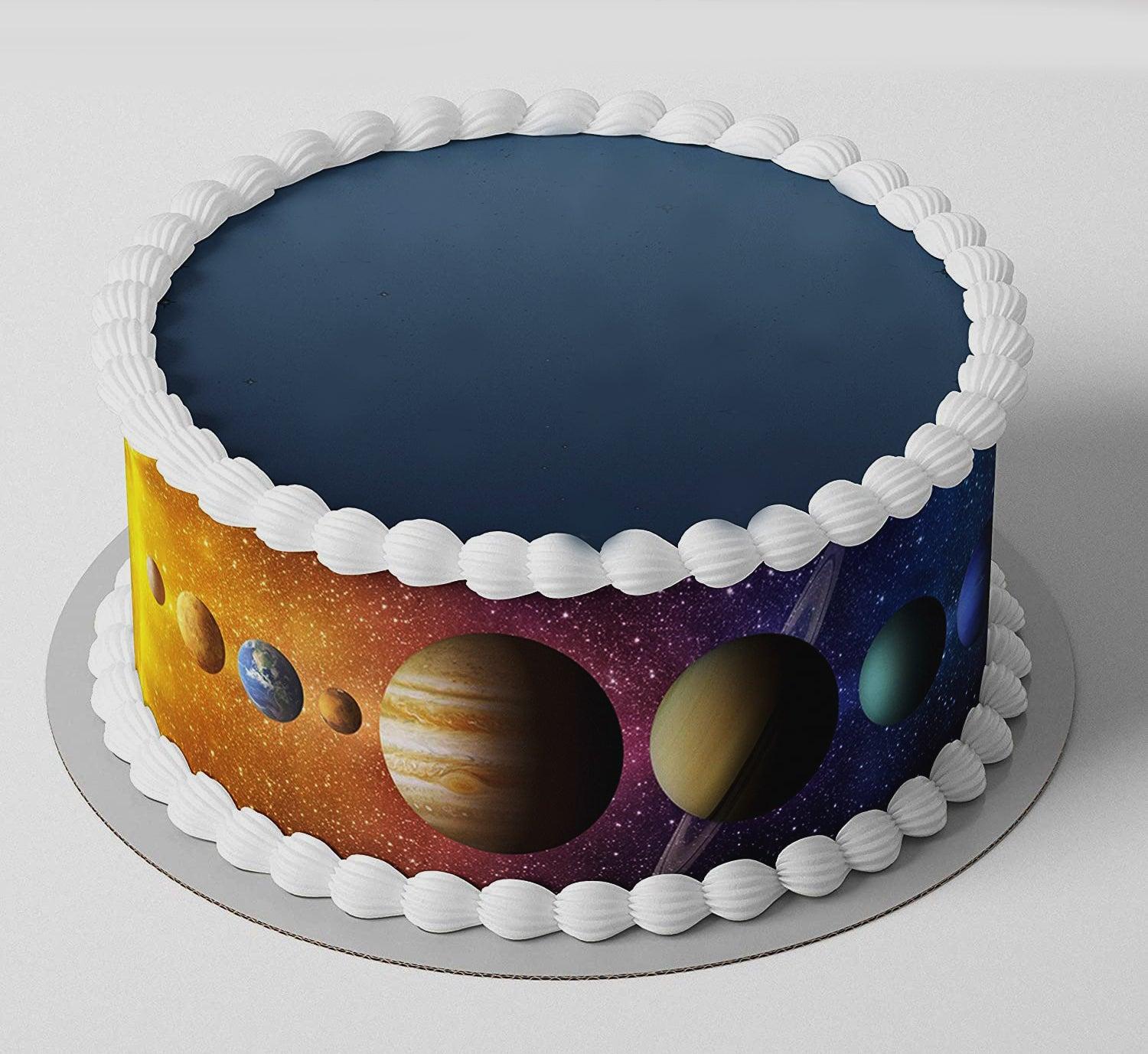 A single-tier space-themed cake featuring a wrap-around printout of the solar system planets and white icing borders.