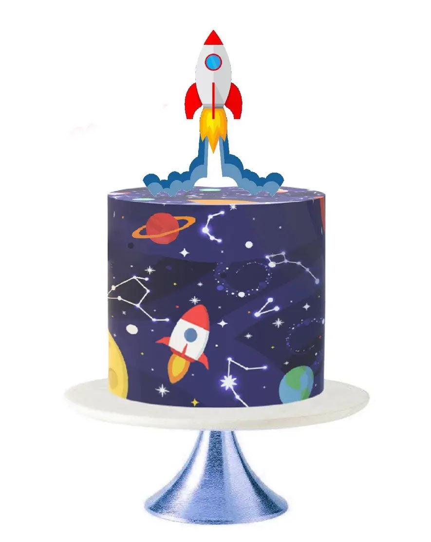 Space themed birthday cake with a rocket ship topper and galaxy print icing featuring planets and constellations.