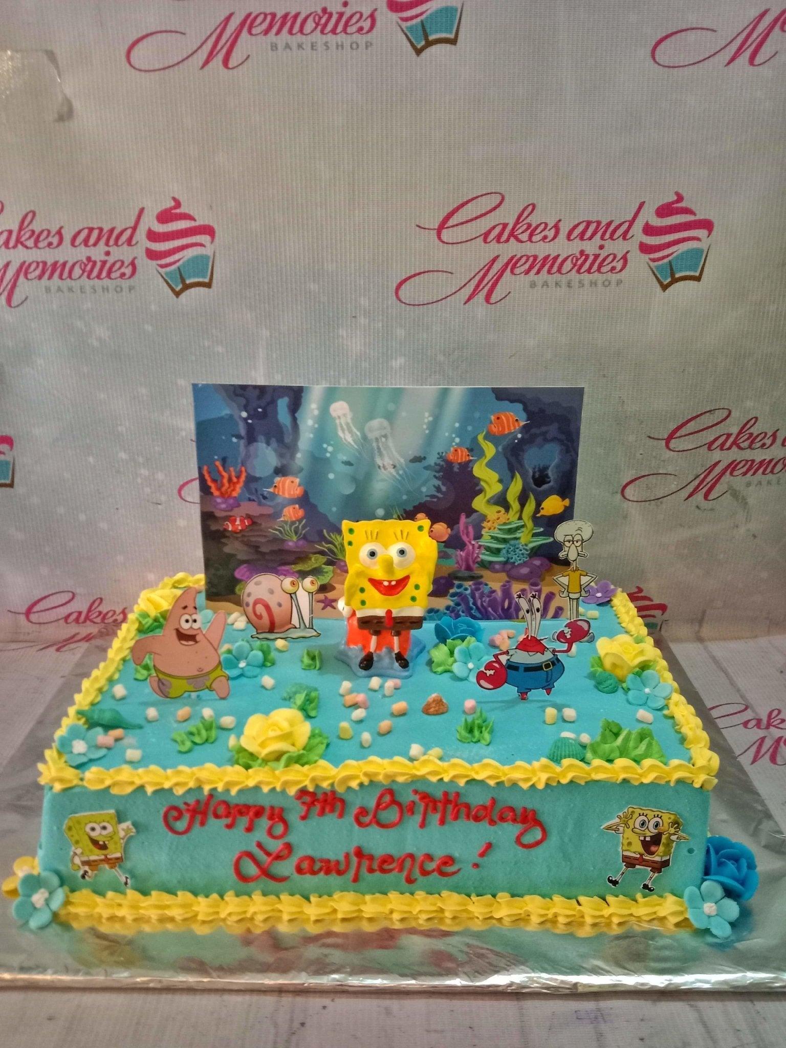 SpongeBob SquarePants themed rectangle cake with blue icing, yellow borders, and character printouts of SpongeBob, Patrick, and Mr. Krabs.