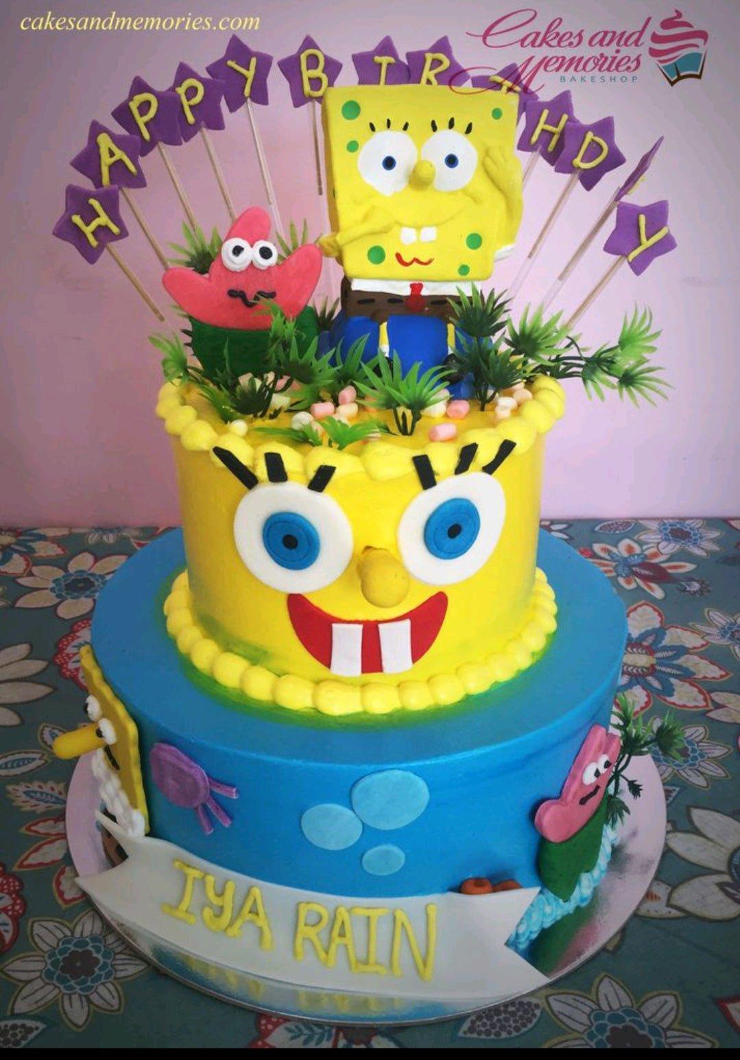 Two-tier Spongebob Squarepants themed cake with yellow and blue fondant, featuring Spongebob and Patrick toppers and a purple star banner.