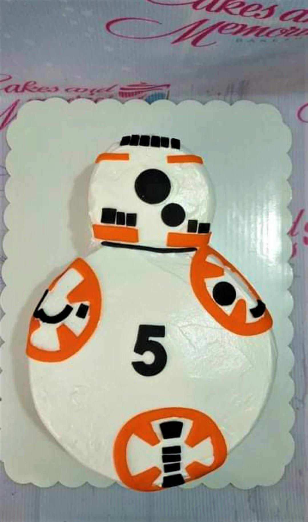 BB-8 Star Wars themed white fondant cake with orange and black geometric details and a black number 5 topper.