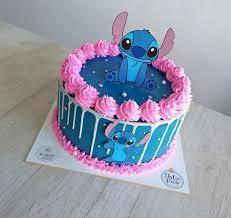 Blue Stitch themed birthday cake with pink icing rosettes and white chocolate drip