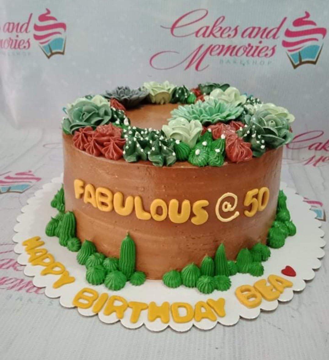 Brown succulent themed birthday cake with green and red icing succulents and yellow gumpaste letters.