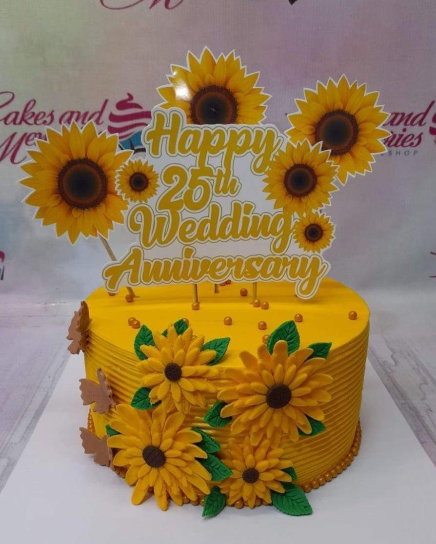 Yellow sunflower themed 25th wedding anniversary cake with large sunflower printouts and edible fondant sunflowers on the side.