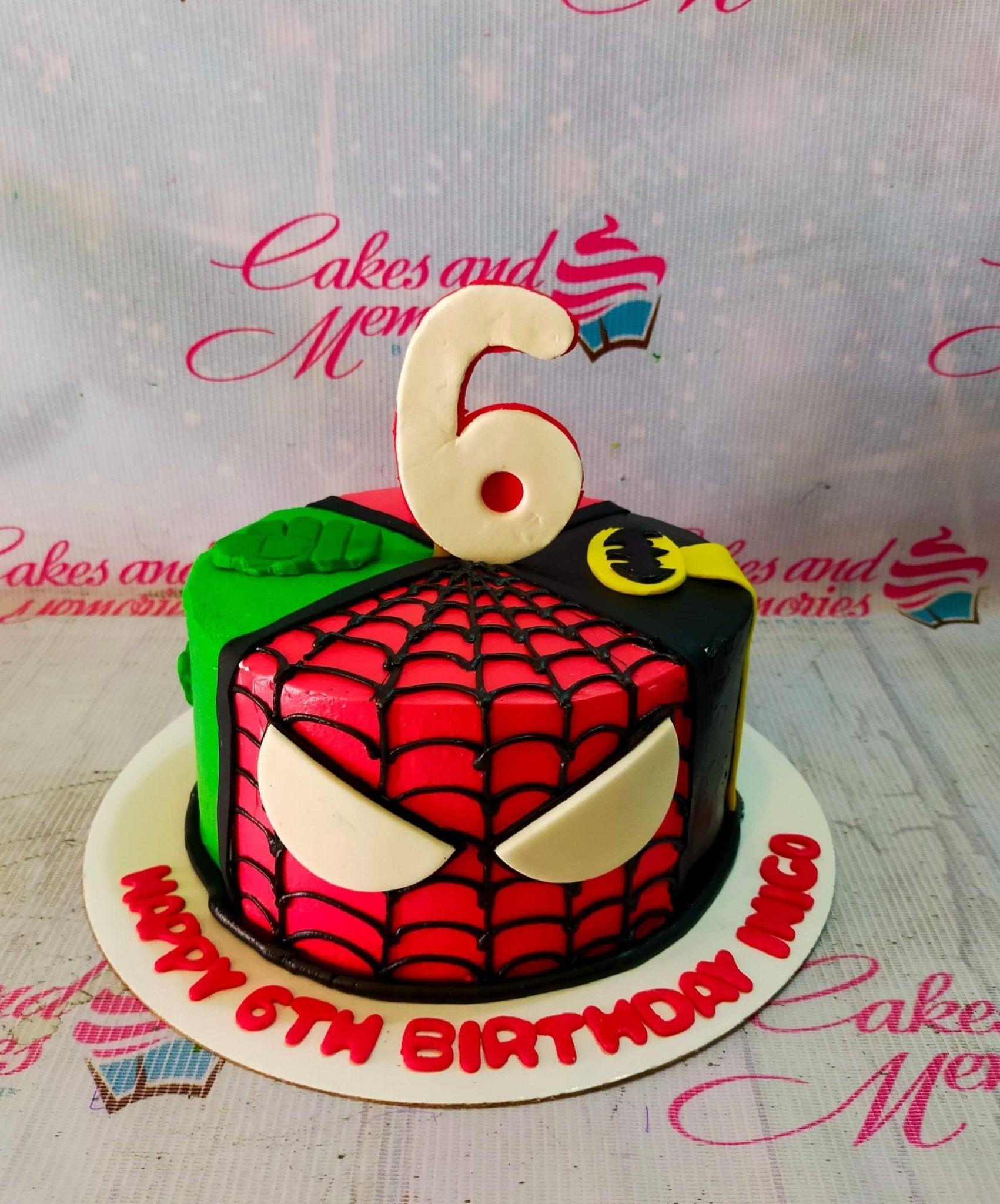 Superhero themed birthday cake featuring Spiderman, Hulk, and Batman designs with a large number 6 topper.