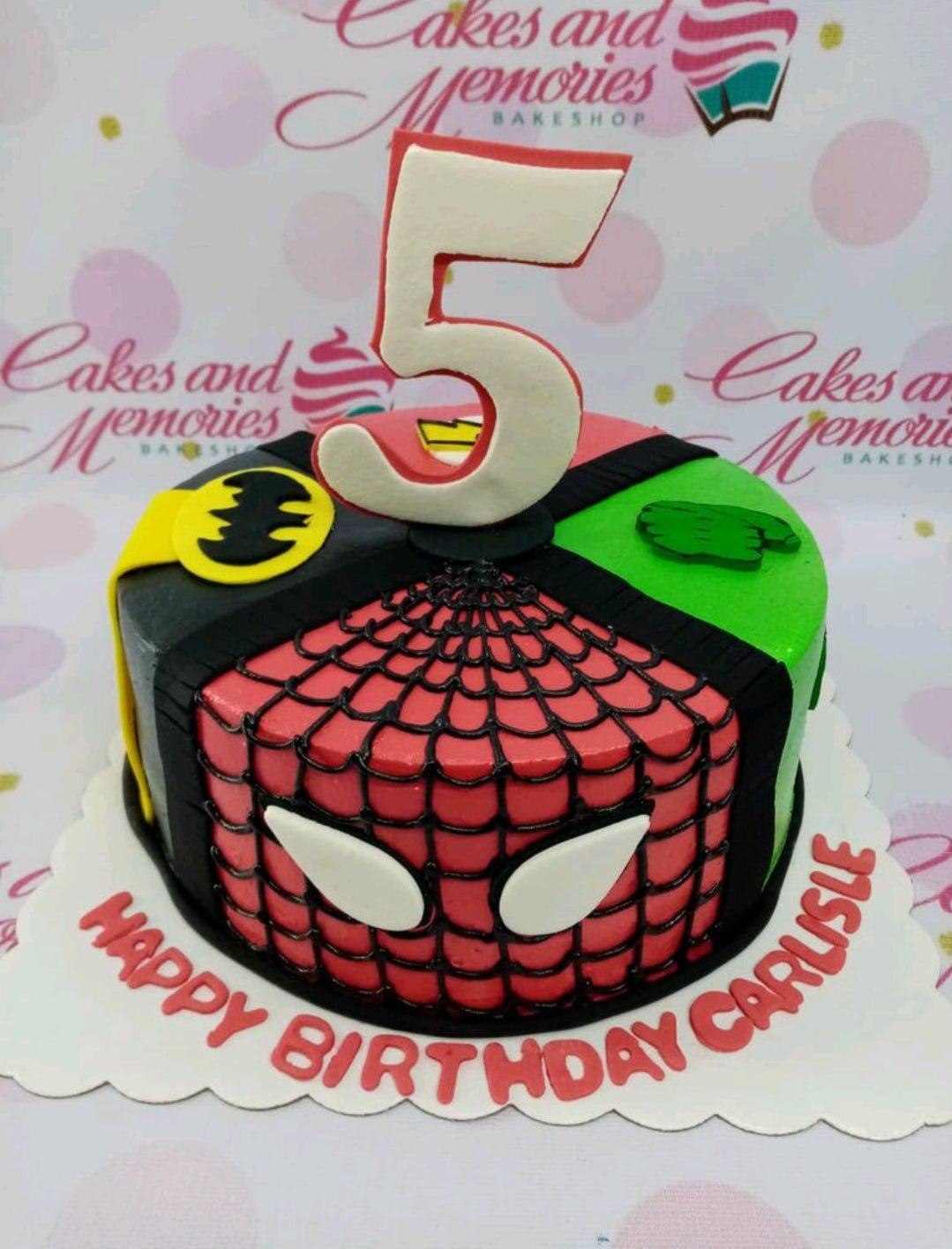 Superhero themed birthday cake featuring Spiderman, Batman, Hulk, and Flash designs with a large number 5 topper.