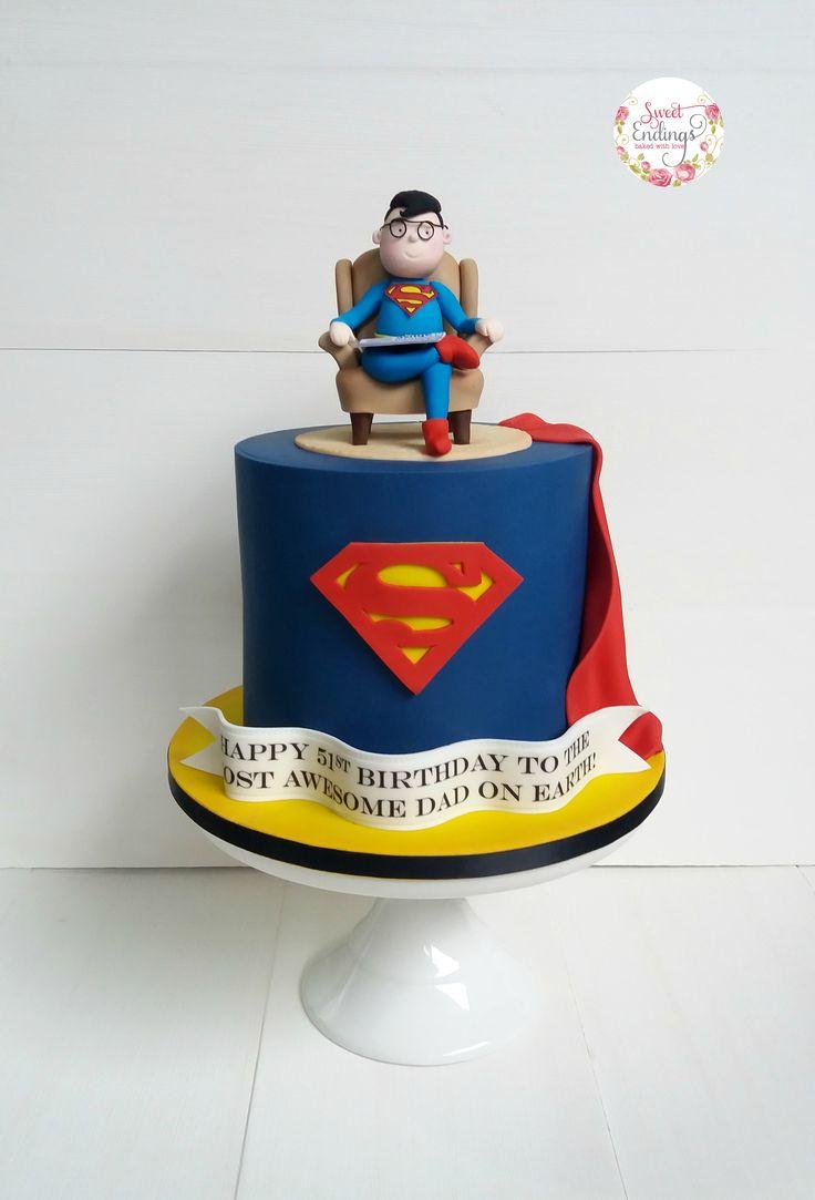 Superman themed birthday cake for dad featuring a custom fondant figure of a man in a Superman suit sitting on a chair.