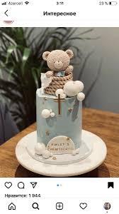 Teddy Bear Baptism 1 Tier - blue, light, white theme with 3D teddy bear sitting in a woven basket and white fondant balls ...