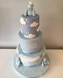Three-tier light blue fondant cake with edible teddy bear figures, white clouds, and silver stars for a baby's birthday or christening.