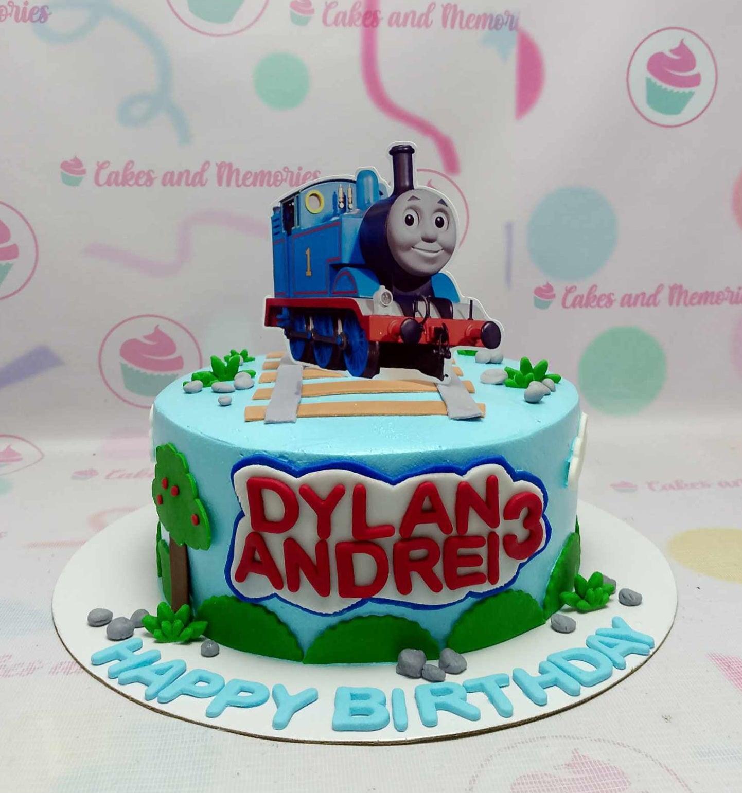 Light blue Thomas the Tank Engine birthday cake with train tracks, fondant trees, and a large character printout for Dylan Andrei's 3rd birthday.