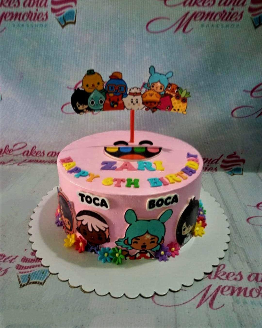 Pink Toca Boca themed birthday cake with colorful character printouts and gumpaste flowers.