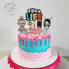 Toca Life themed birthday cake with blue and pink icing, pink drip, and character printouts on top.
