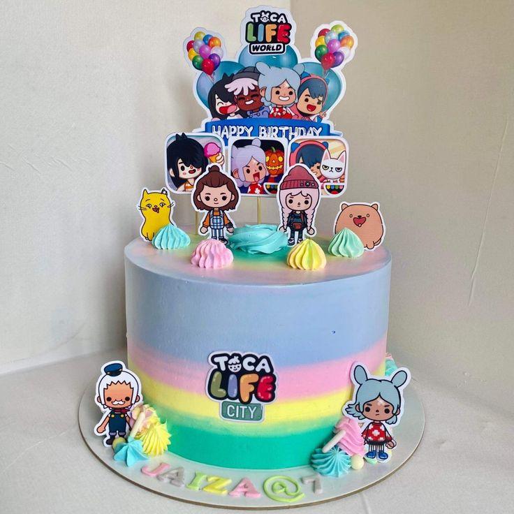 Toca Life World themed birthday cake with rainbow gradient icing, character printouts, and colorful icing rosettes.