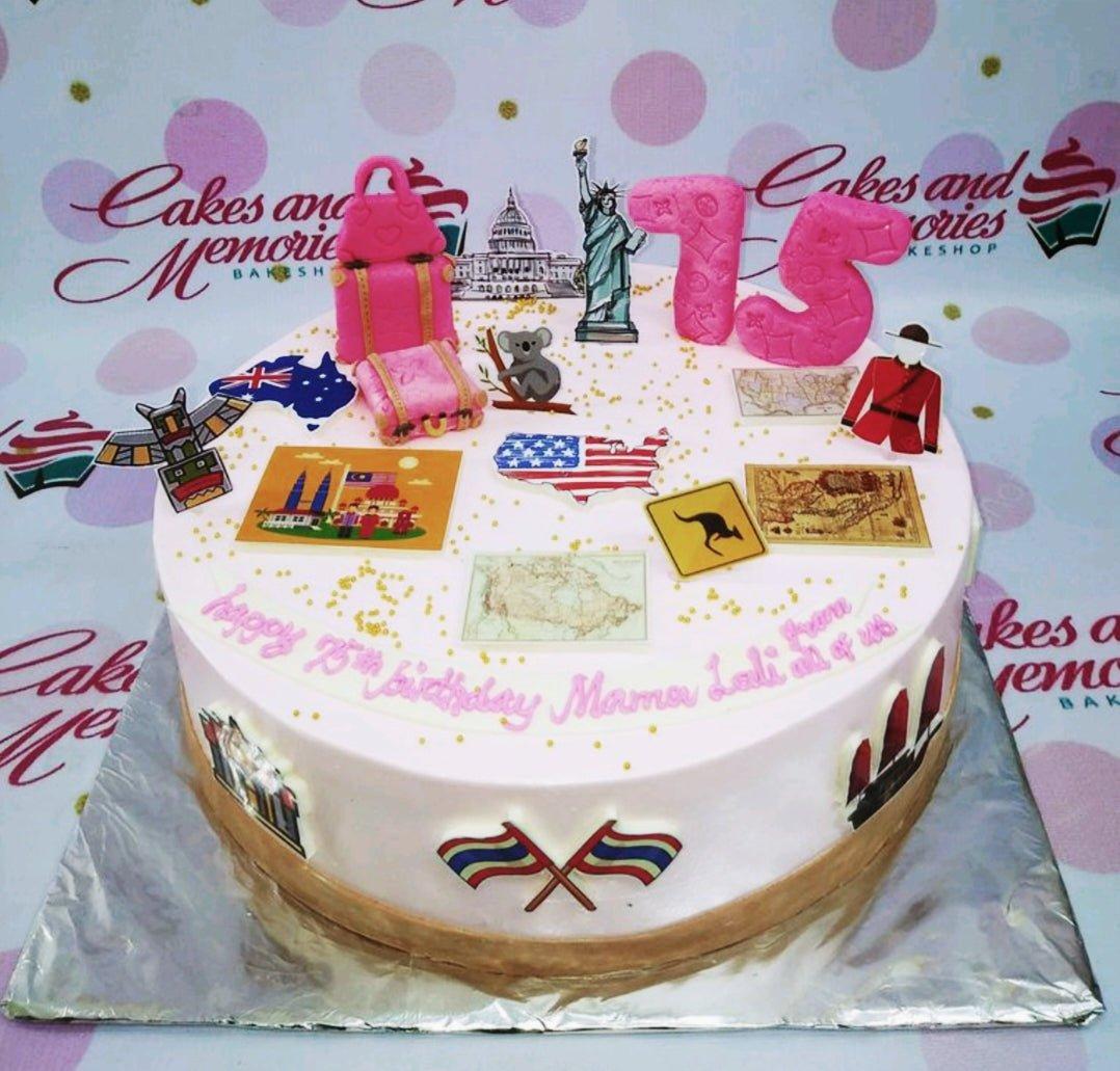 White 1-tier travel themed birthday cake with pink luggage, 75th birthday message, and various world landmark printouts.