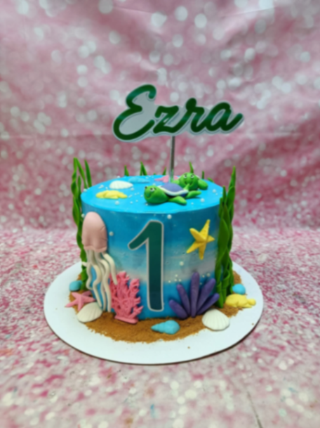 Under the sea, 1st birthday 1 Tier - green, yellow, white theme with Ezra name topper and green seaweed