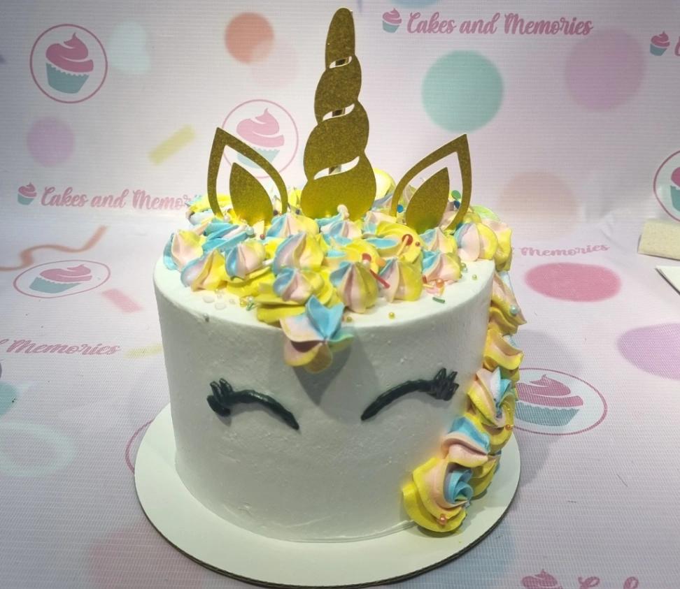 unicorn 1 Tier - red, white, gold theme with cardstock unicorn horn and multi-colored icing swirls