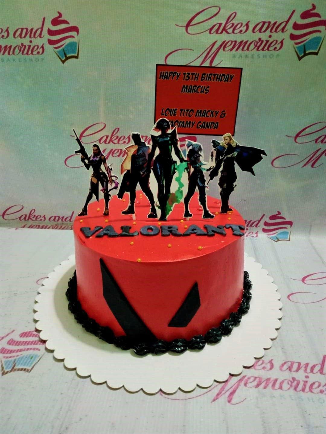 Red Valorant themed birthday cake with character printouts and black icing border