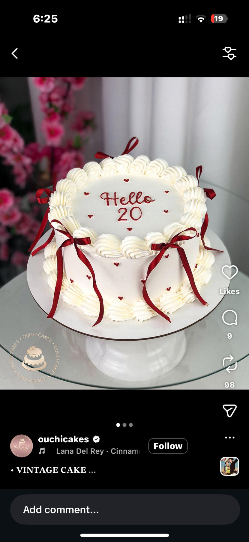 White vintage minimalist cake with red ribbon bows and piped icing borders featuring a Hello 20 message.