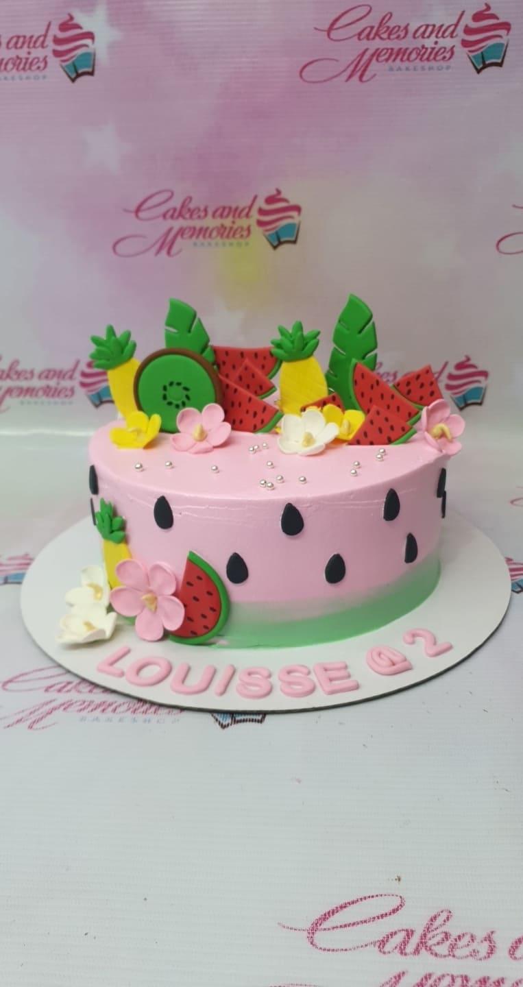 Pink watermelon themed birthday cake with fondant fruit slices, flowers, and silver dragees for Louisse's 2nd birthday.