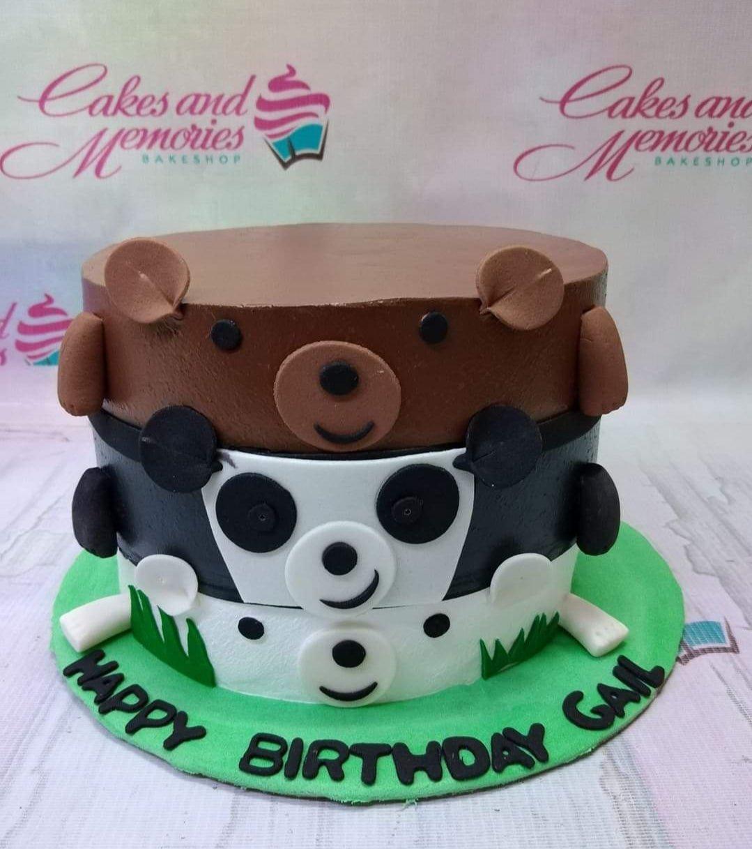 Three-tier stack effect cake featuring a brown bear, panda, and polar bear with green grass and a birthday message on a green base.