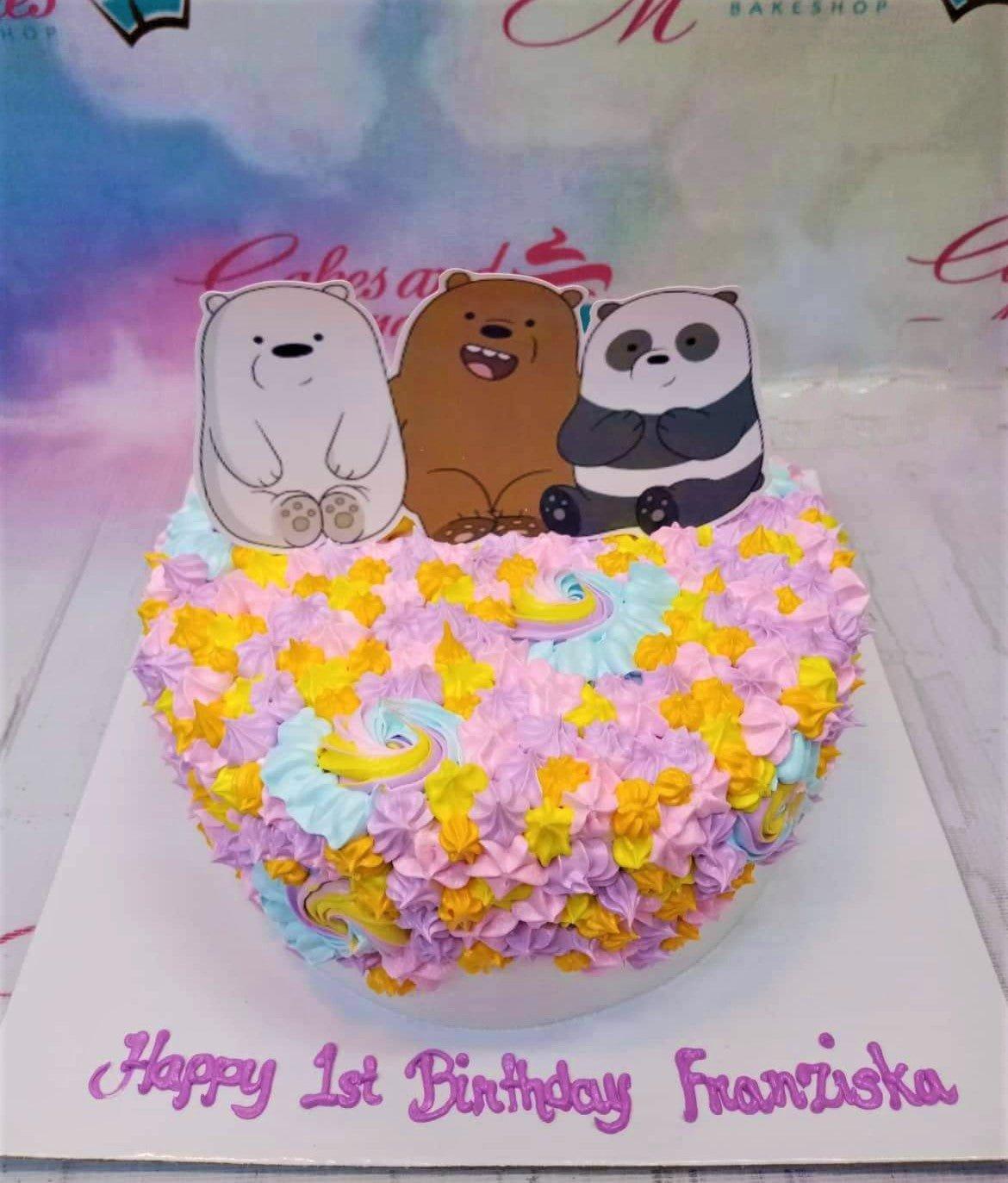 Colorful We Bare Bears birthday cake with pink, yellow, and blue icing rosettes and character printouts.