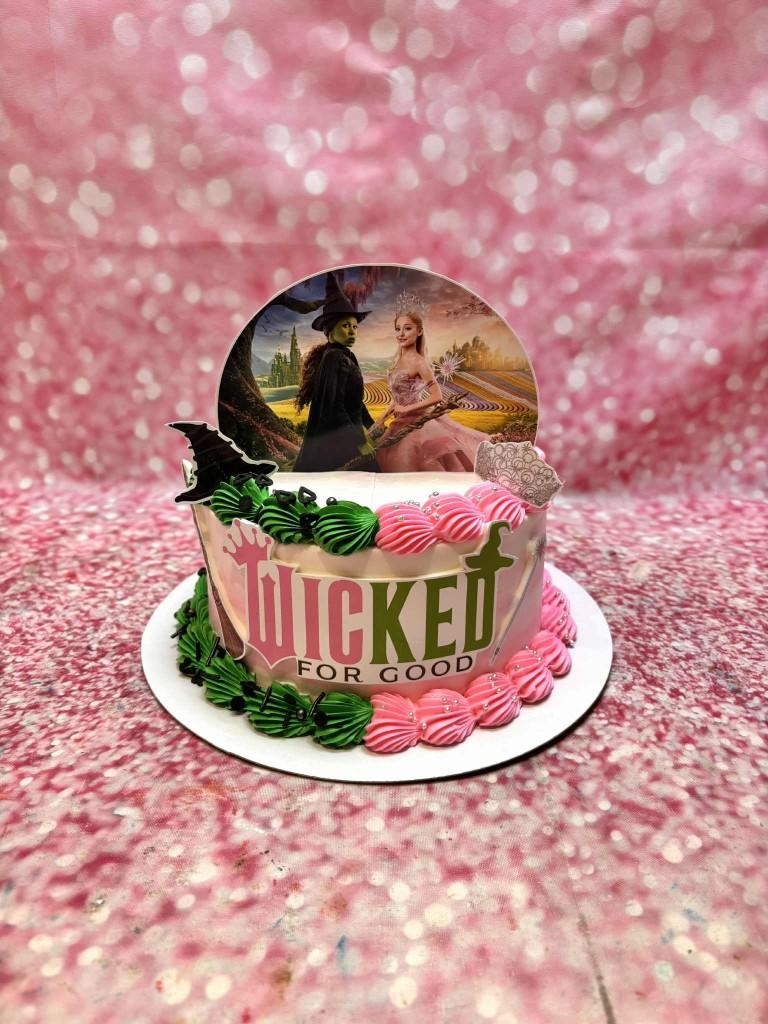 Wicked musical 1 Tier - black, silver, green theme with Wicked movie poster with Elphaba and Glinda and green icing swirls