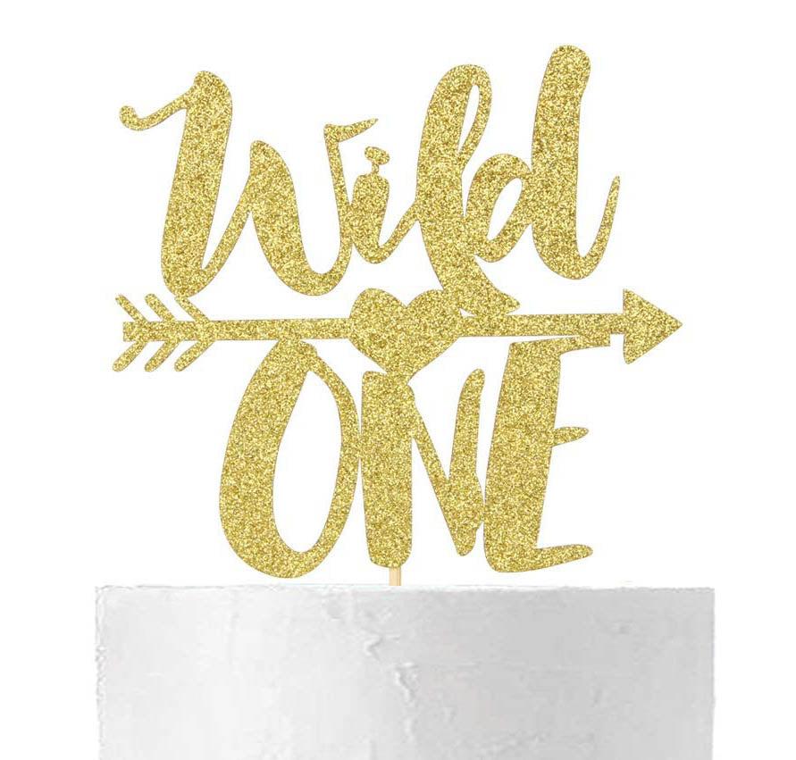 White minimalist cake with a large gold glitter Wild One topper featuring an arrow and heart design.