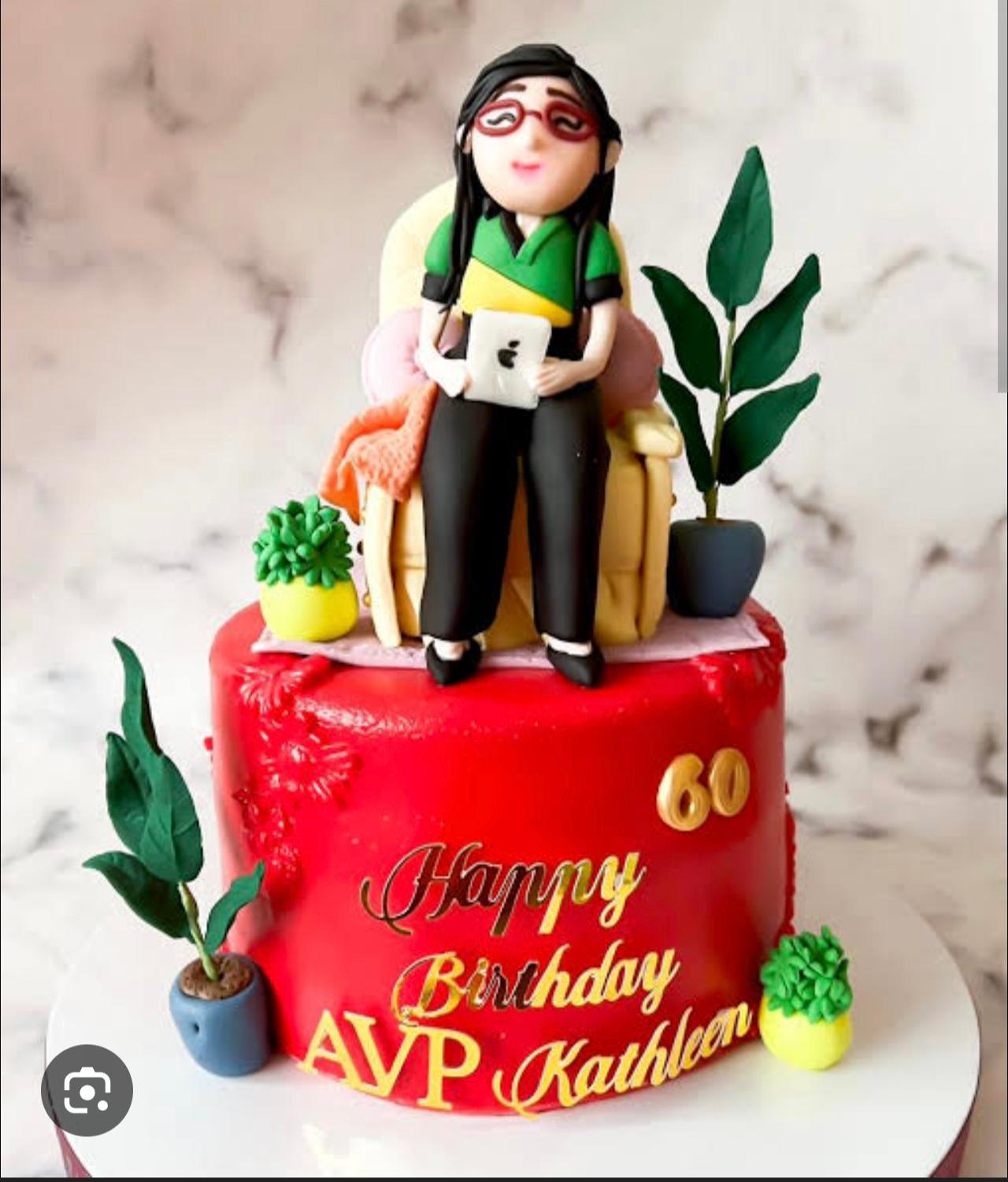 woman figurine 1 Tier Fondant - red theme with woman sitting on a chair holding a tablet and potted succulent plant