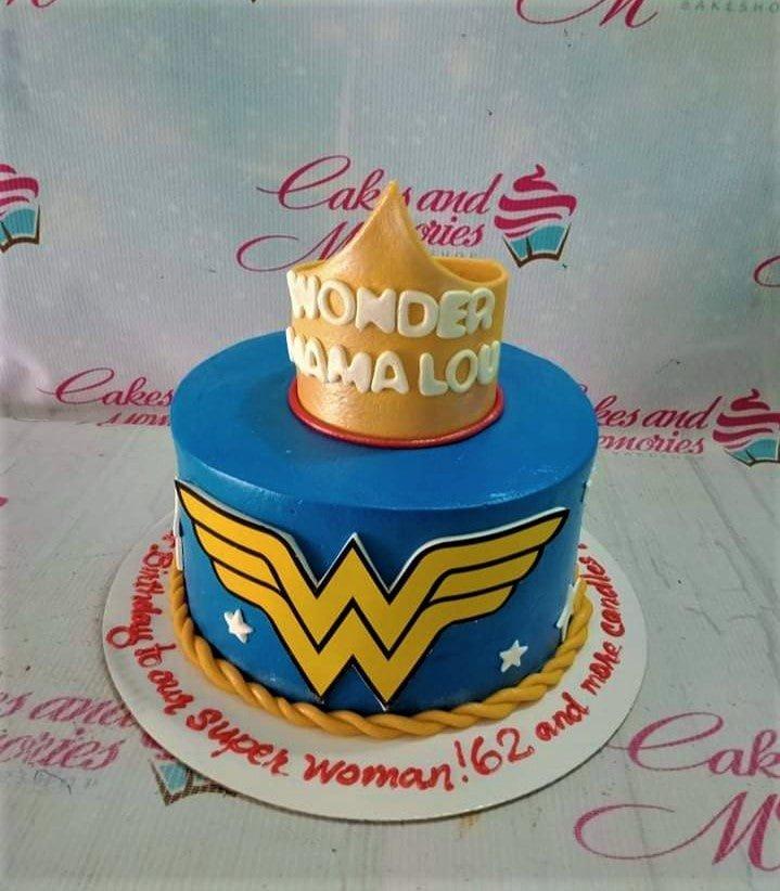 Blue Wonder Woman themed cake with a gold fondant crown topper and the Wonder Woman logo on the side.