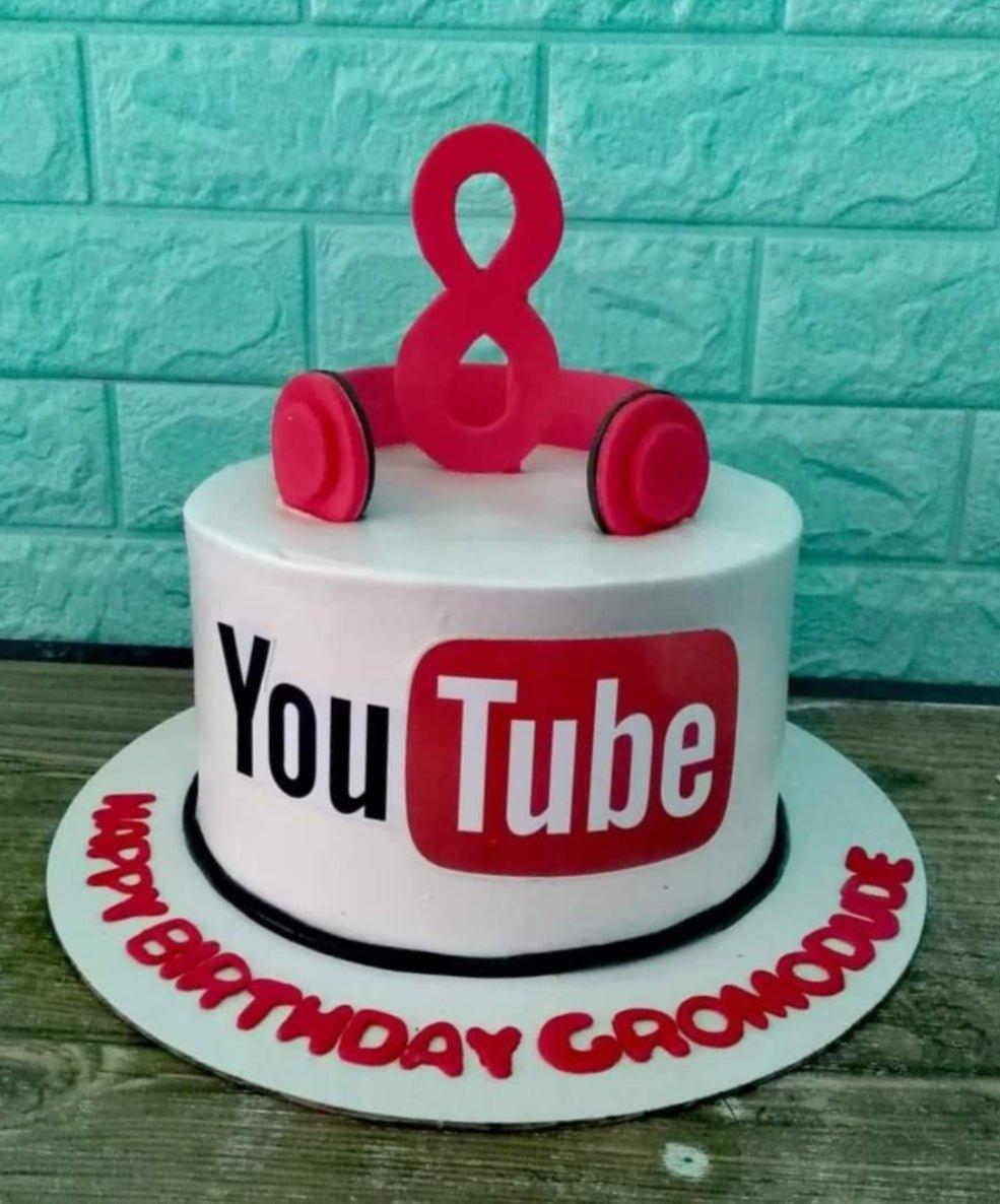 White 1-tier YouTube themed birthday cake with red headphones and a large number 8 topper.