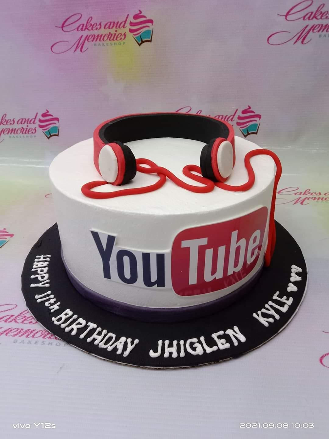 White 1-tier YouTube themed birthday cake with red fondant headphones and a large YouTube logo on the side.